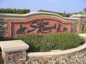 Silva Ranch sign with stone and greenery.