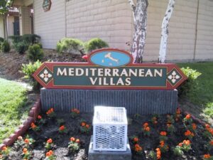 Sign for Mediterranean Villas with flowers