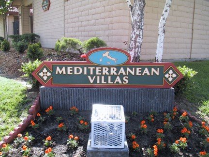 Sign for Mediterranean Villas with flowers