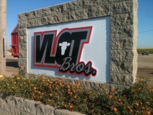 Vlot Bros sign with flowers in foreground