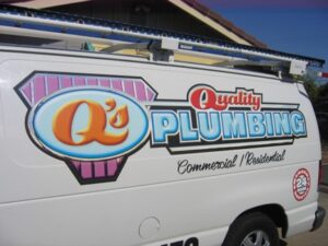 Q's Plumbing service van with colorful logo