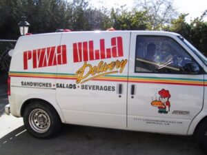 Pizza delivery van with colorful branding.