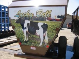 Trailer with cow graphic and 'Lucky Bell' sign.