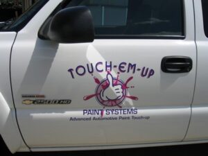 White truck with automotive paint touch-up logo.
