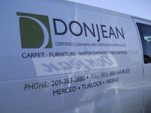 DonJean cleaning service van with contact information