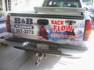 B&B Plumbing truck with contact and service information
