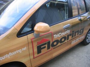 Car with TriCounty Flooring advertisement and logo.