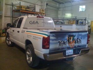 White truck with livestock-themed advertisement