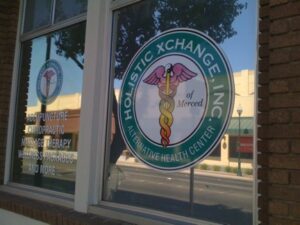 Holistic health center window display with logo.