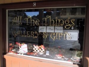Storefront display of All The Things Gallery.