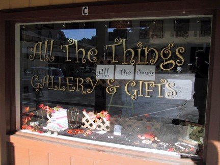 Storefront display of All The Things Gallery.